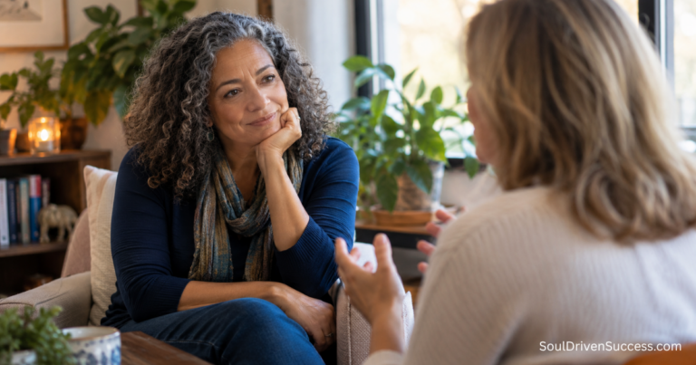 Two women having a thoughtful coaching conversation in a warm, comfortable setting, reflecting the power of coaching to help people discover their truth.